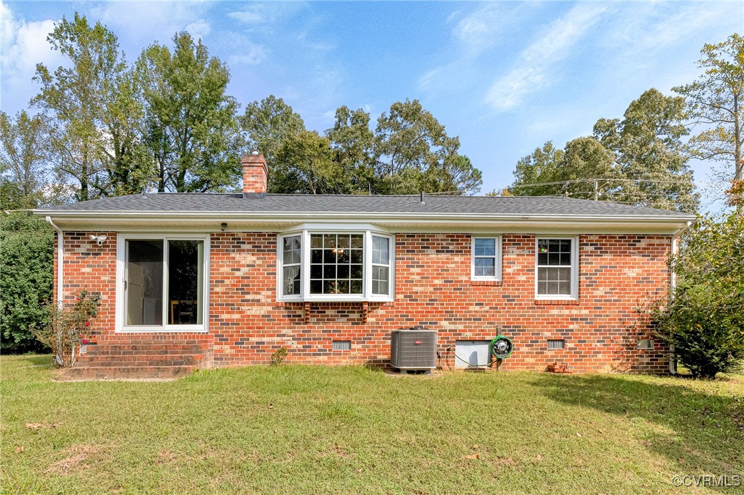 3050 Rose Mount Road Walkerton, VA 23177 - Photo 24 of 35 Rear view of house with a yard and central AC