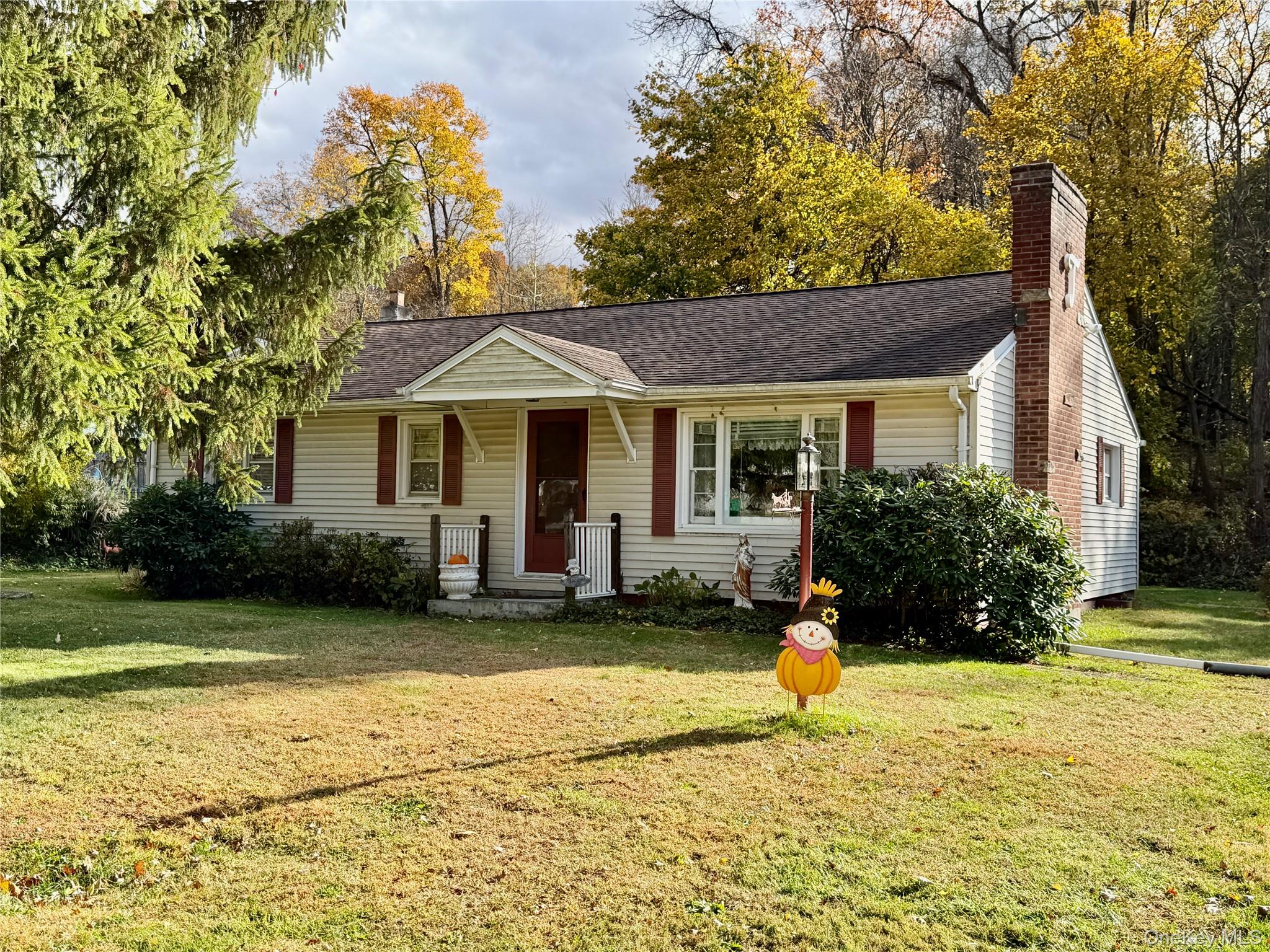 a house that has a tree in front of it