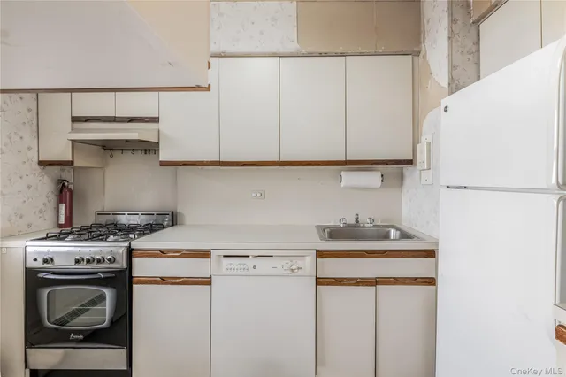 a kitchen with a stove and a refrigerator
