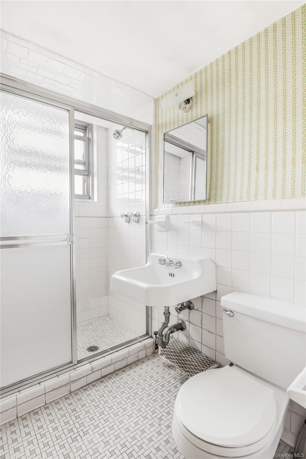 61-25 97th Street, Unit 15F Queens, NY 11374 - Photo 18 of 26 a bathroom with a sink a toilet and shower