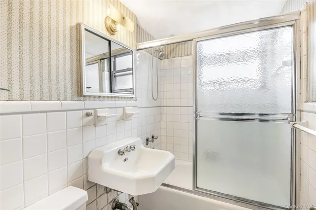 a bathroom with a sink shower and a toilet