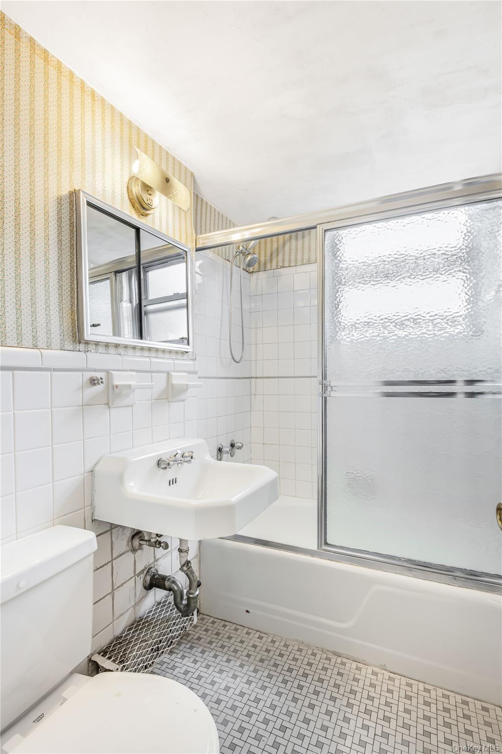 61-25 97th Street, Unit 15F Queens, NY 11374 - Photo 20 of 26 a bathroom with a sink a toilet and shower