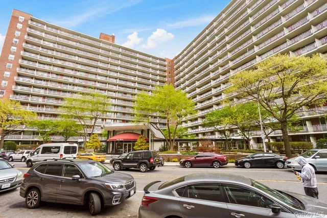 a view of parking with cars parked in front of a building