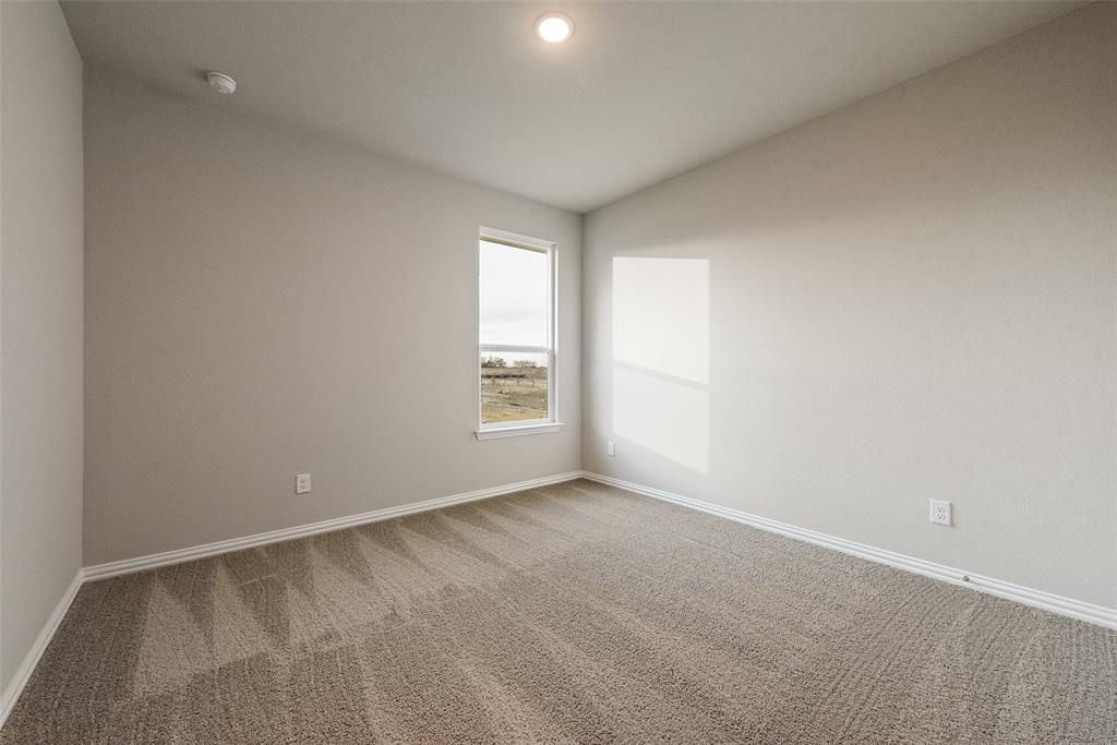 1230 County Road 200 Valley View, TX 76272 - Photo 19 of 26 Unfurnished room with carpet floors, vaulted ceiling, and recessed lighting