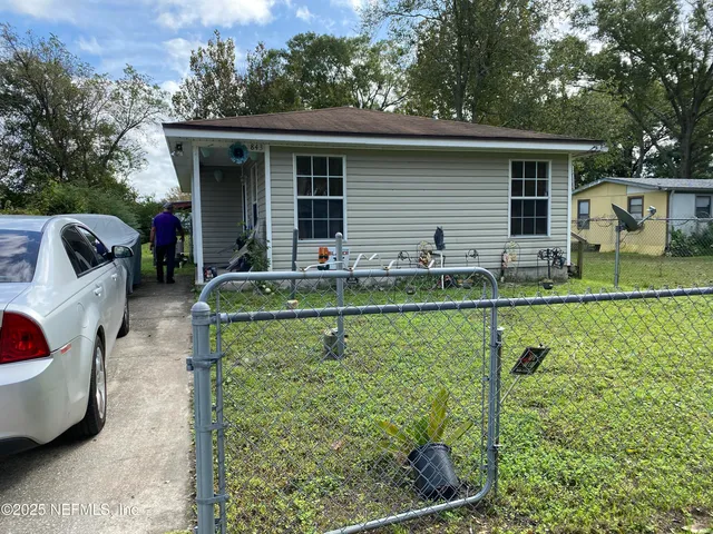 a backyard of a house with barbeque oven