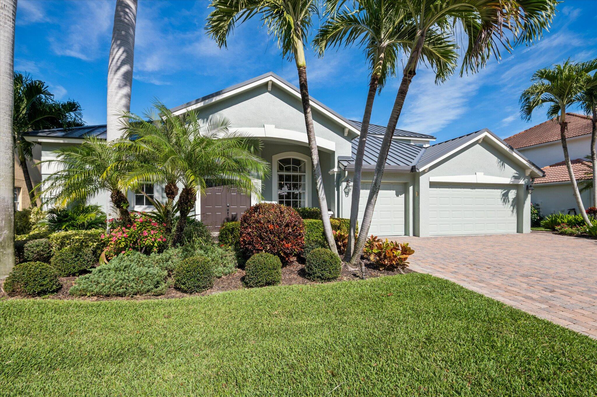 7299 Serrano Terrace Delray Beach, FL 33446 - Photo 2 of 39 front view of a house with a yard