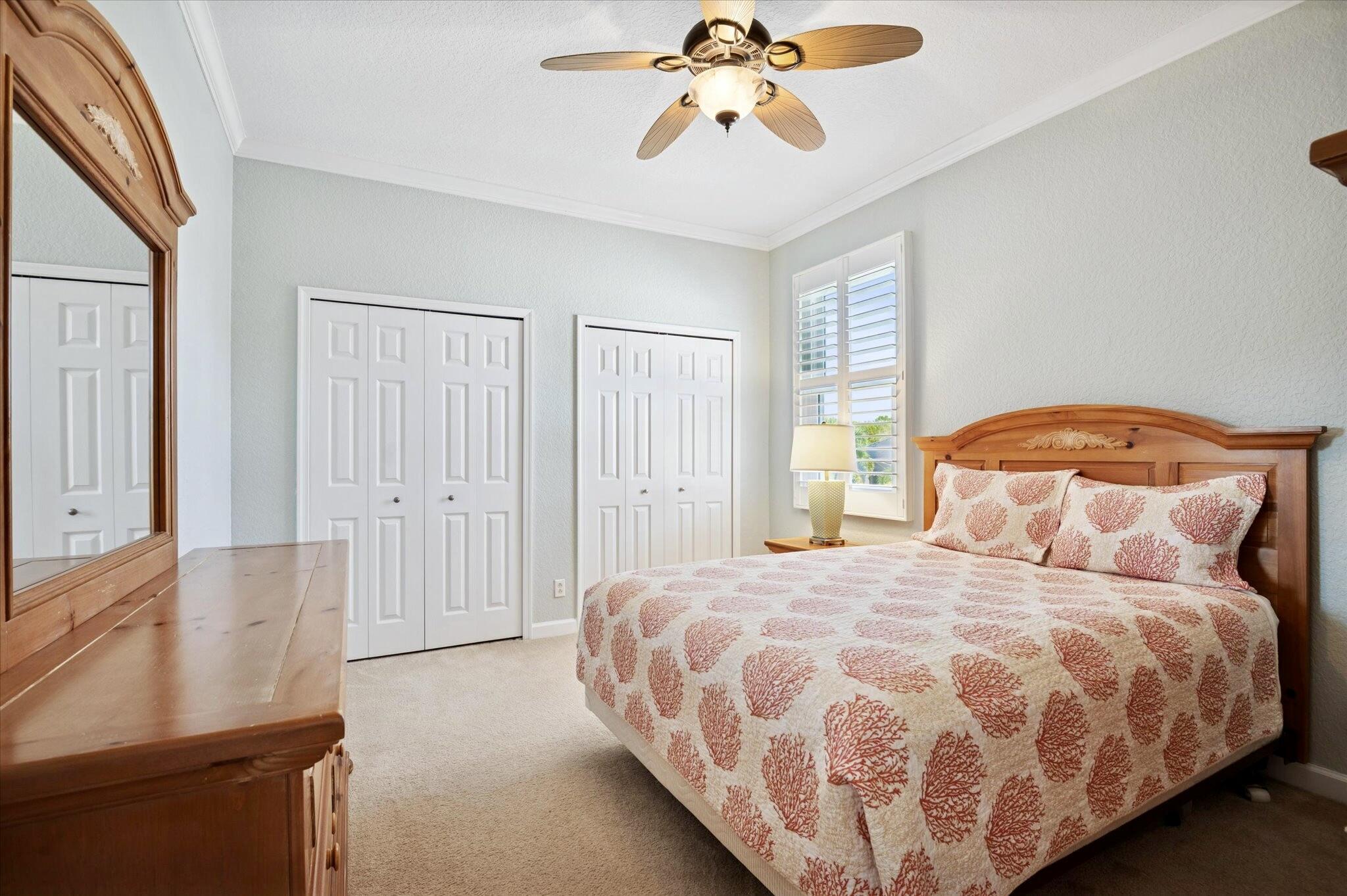 7299 Serrano Terrace Delray Beach, FL 33446 - Photo 26 of 39 a bedroom with a bed and a chandelier