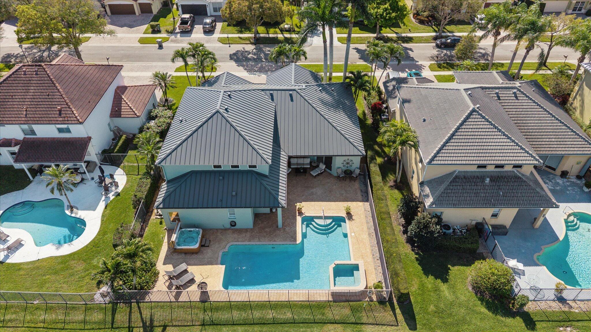 7299 Serrano Terrace Delray Beach, FL 33446 - Photo 3 of 39 an aerial view of a house with a swimming pool and outdoor seating