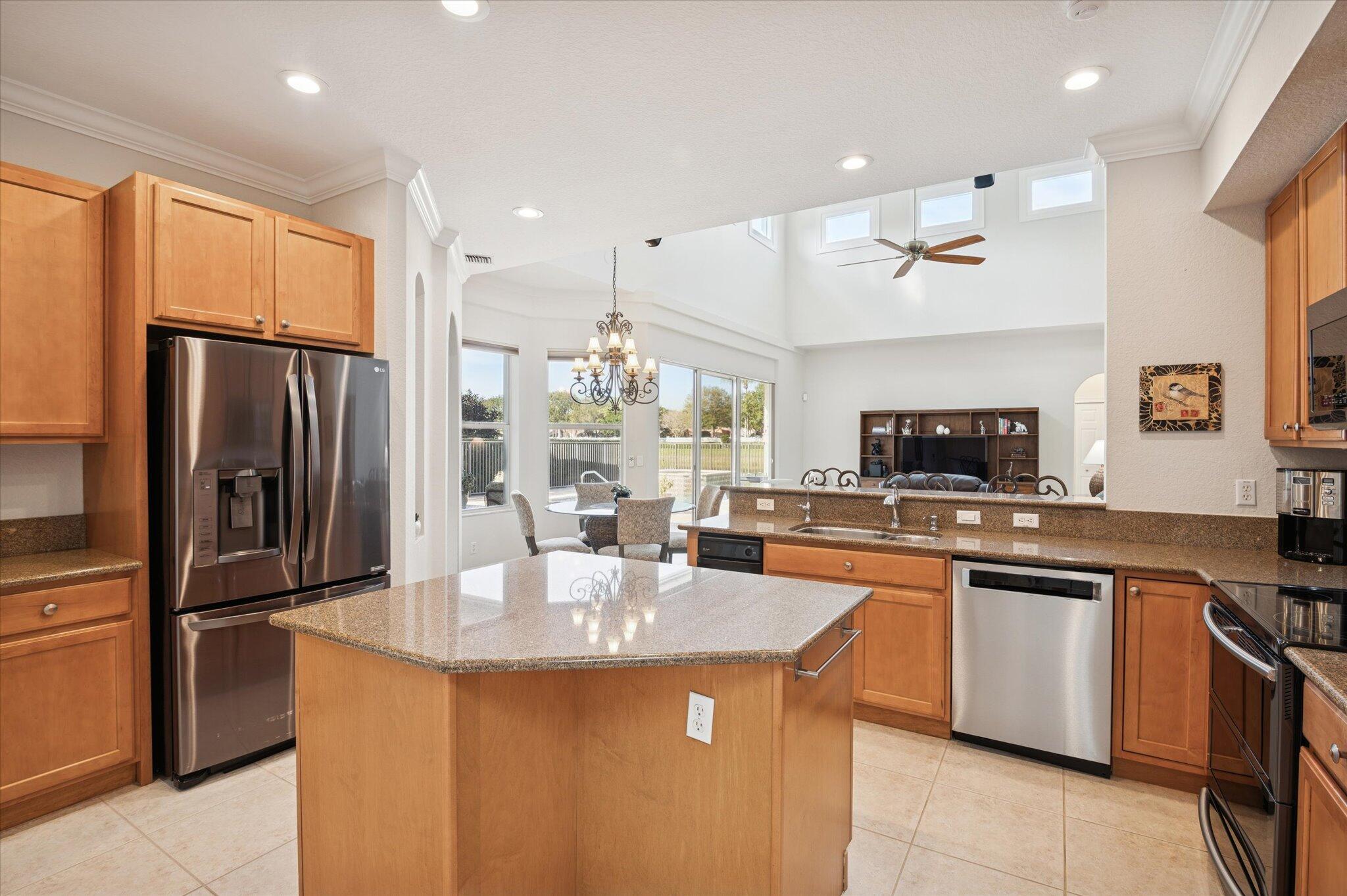 7299 Serrano Terrace Delray Beach, FL 33446 - Photo 10 of 39 a kitchen with stainless steel appliances granite countertop a sink stove and refrigerator