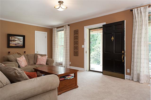A true living room to welcome family and friends into your home - large windows bring in great light.