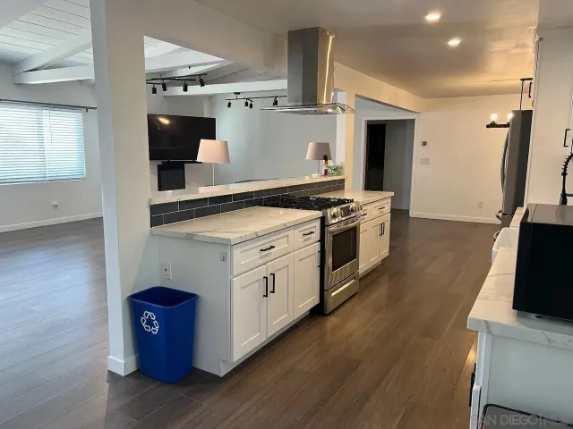 a kitchen with stainless steel appliances granite countertop a stove and a refrigerator