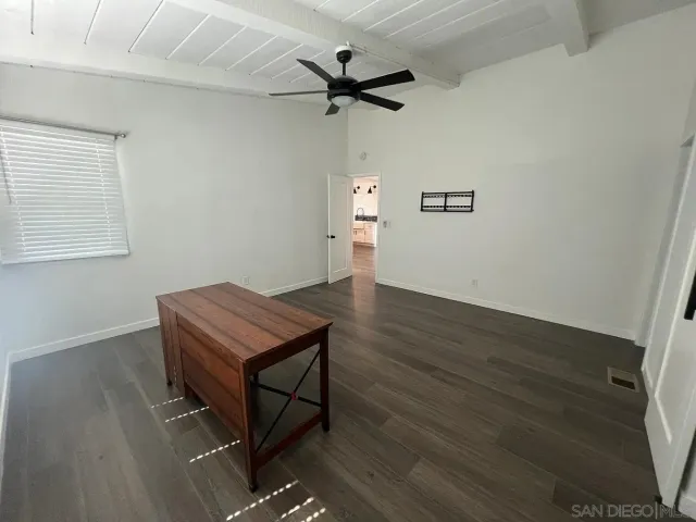 a room with a table and a ceiling fan