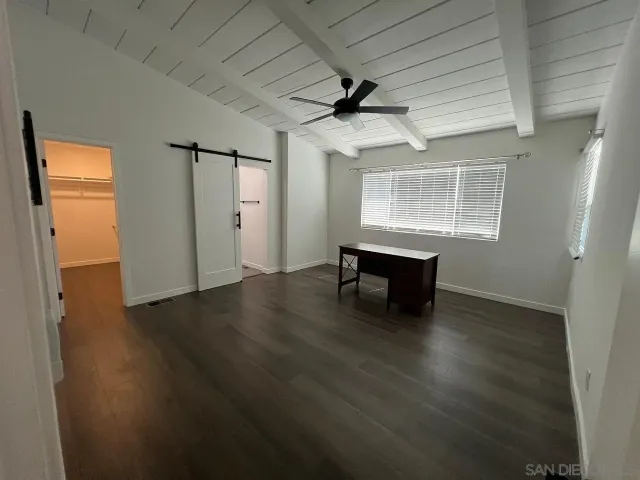 a view of a livingroom with wooden floor and a window