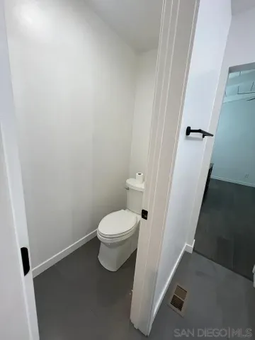 a white toilet sitting next to a white sink