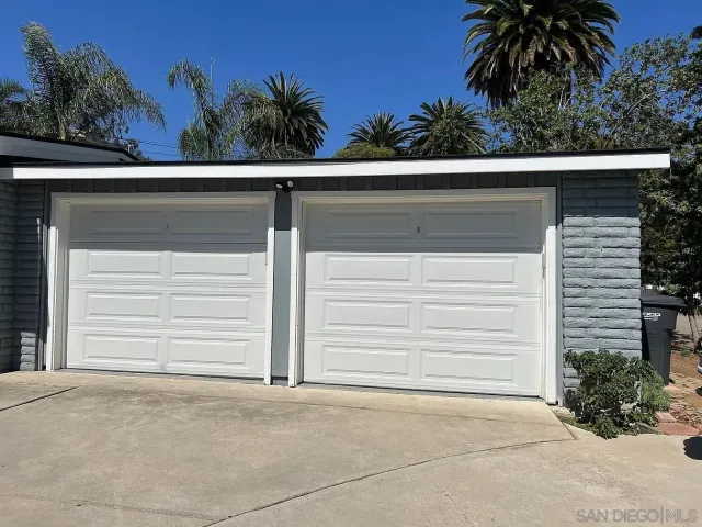a small white house with outdoor space
