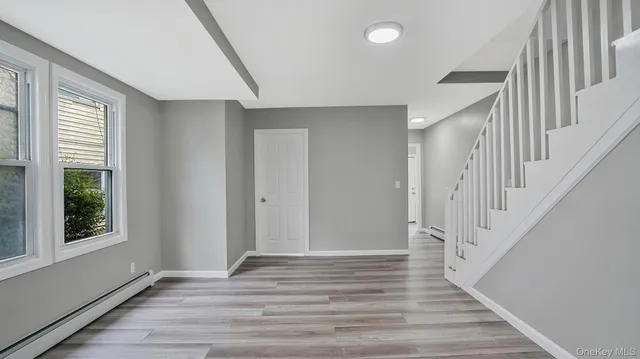 a view of an entryway with wooden floor and door
