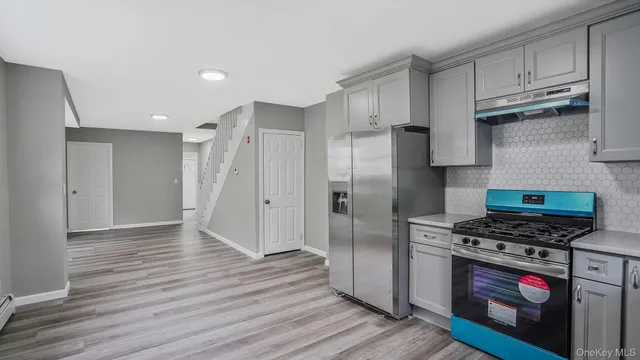 a kitchen with stainless steel appliances a refrigerator and a stove top oven