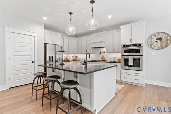 a kitchen with stainless steel appliances a stove a refrigerator and a microwave