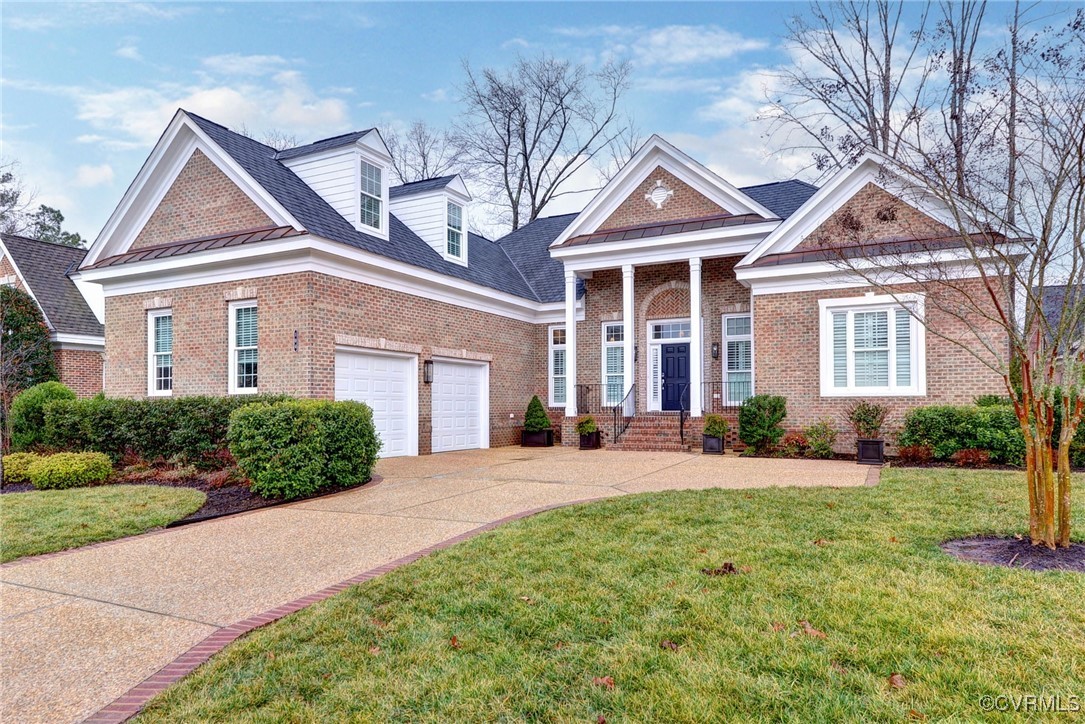 a front view of a house with yard and green space