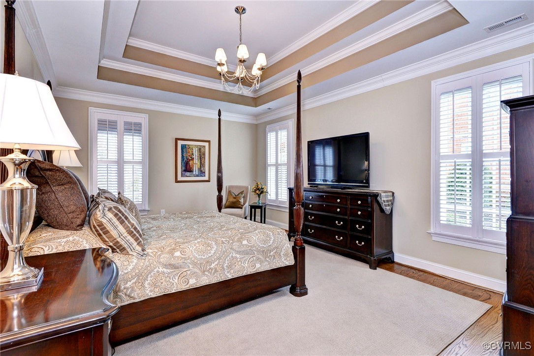 104 Edenbridge Williamsburg, VA 23188 - Photo 22 of 50 a bedroom with a bed and a flat tv screen on a dresser