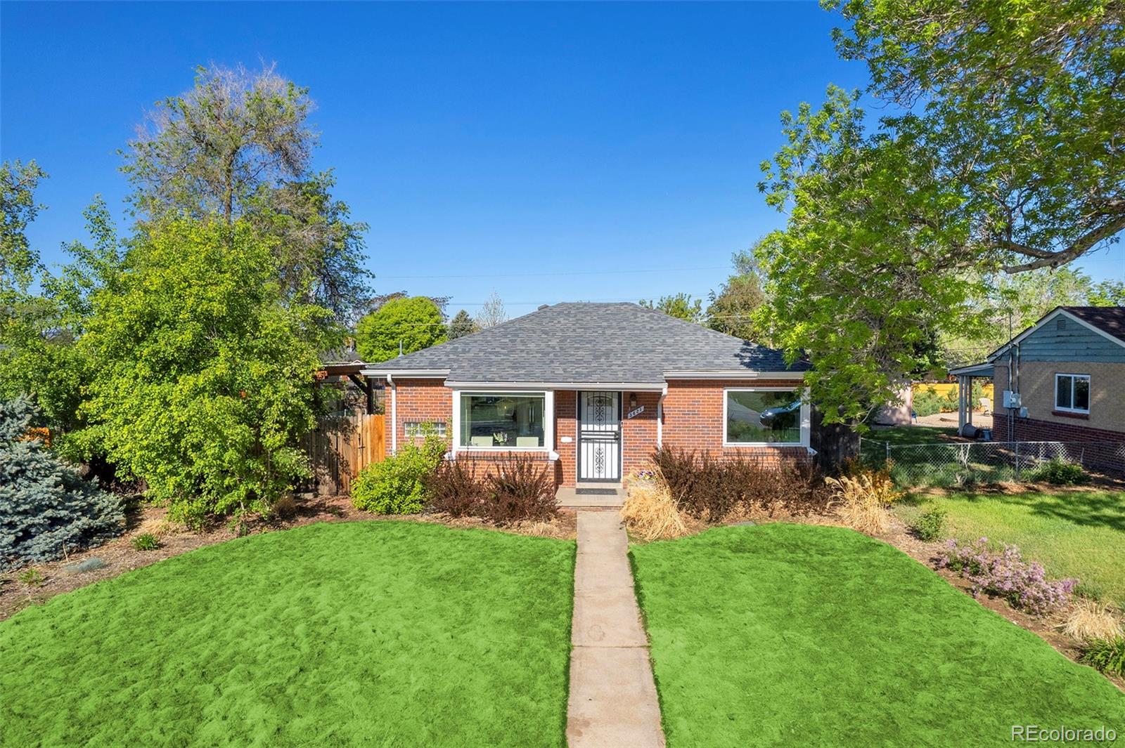 a view of a house with a yard and plants