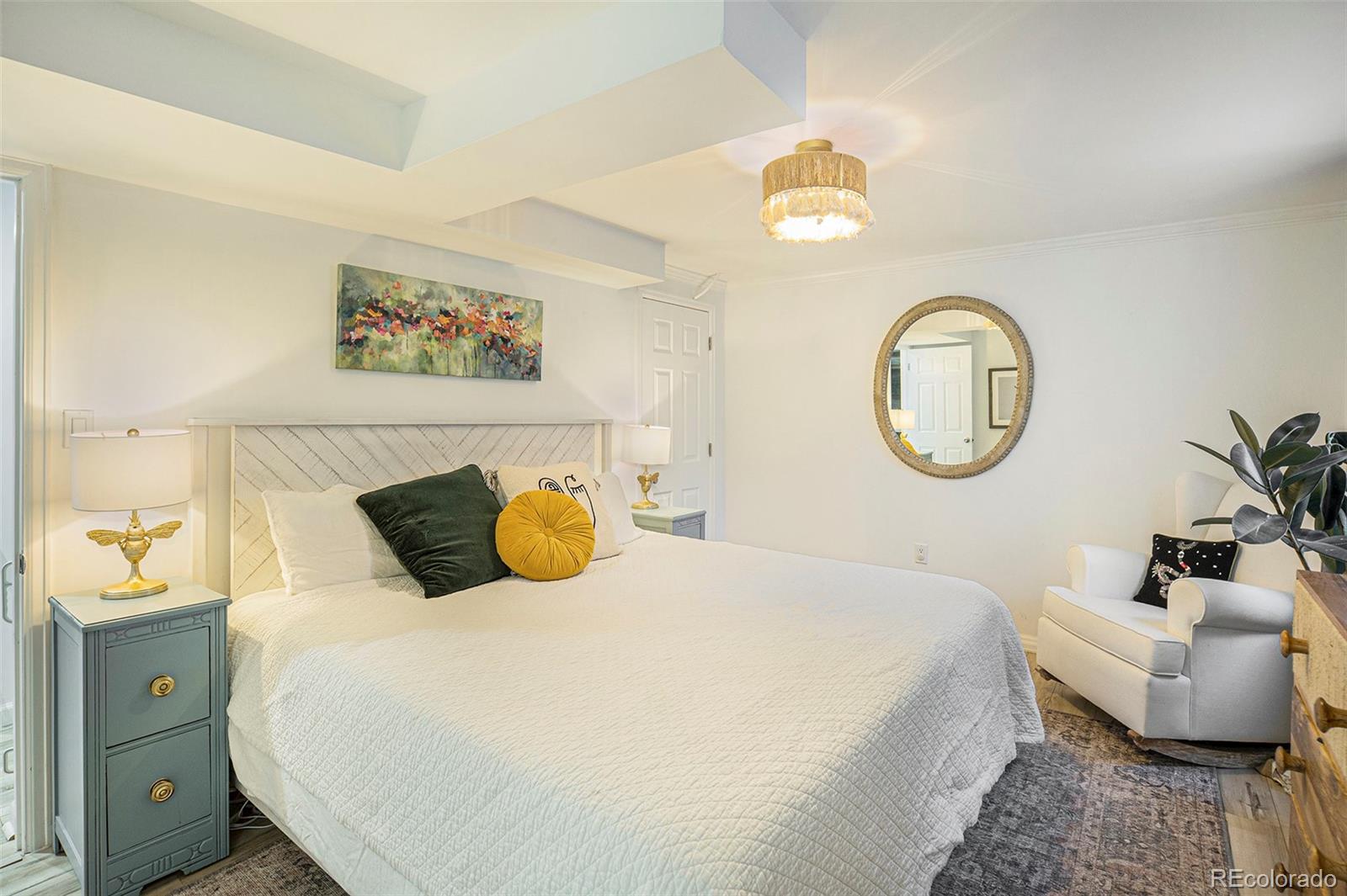 3621 Oneida Street Denver, CO 80207 - Photo 18 of 35 a bedroom with a bed a mirror and a window