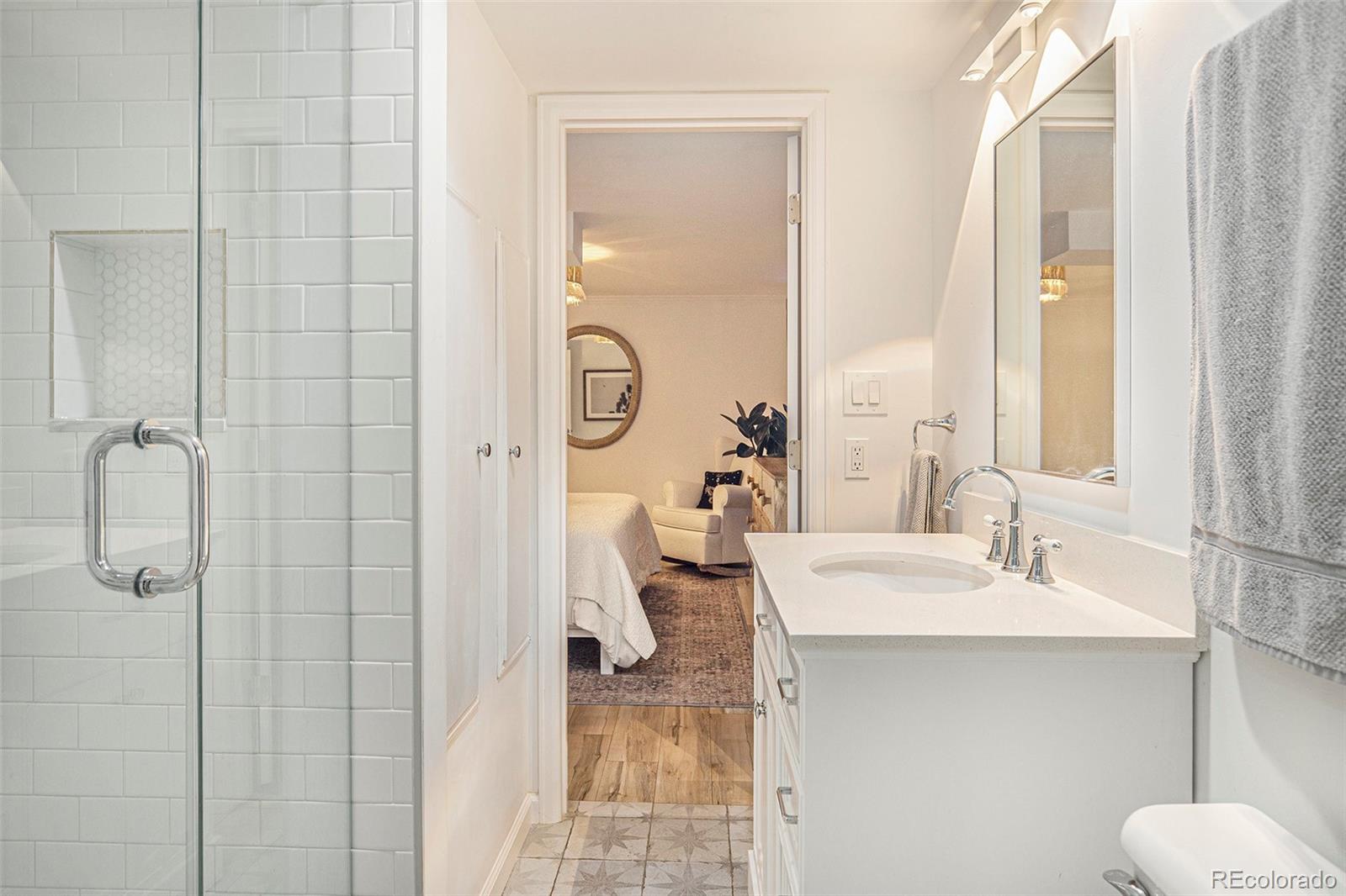 3621 Oneida Street Denver, CO 80207 - Photo 19 of 35 a bathroom with a sink toilet and shower