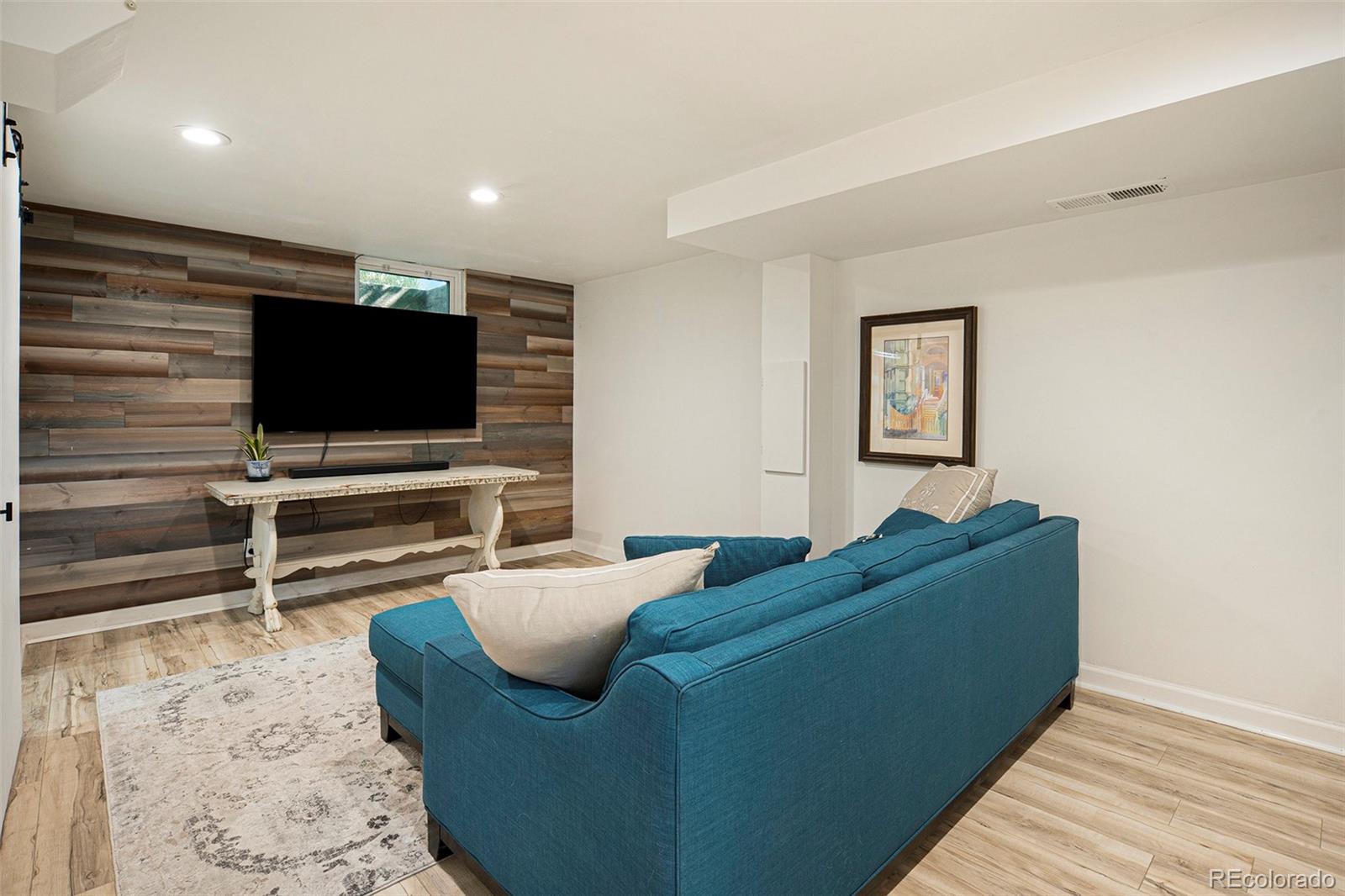 3621 Oneida Street Denver, CO 80207 - Photo 20 of 35 a living room with furniture and a flat screen tv