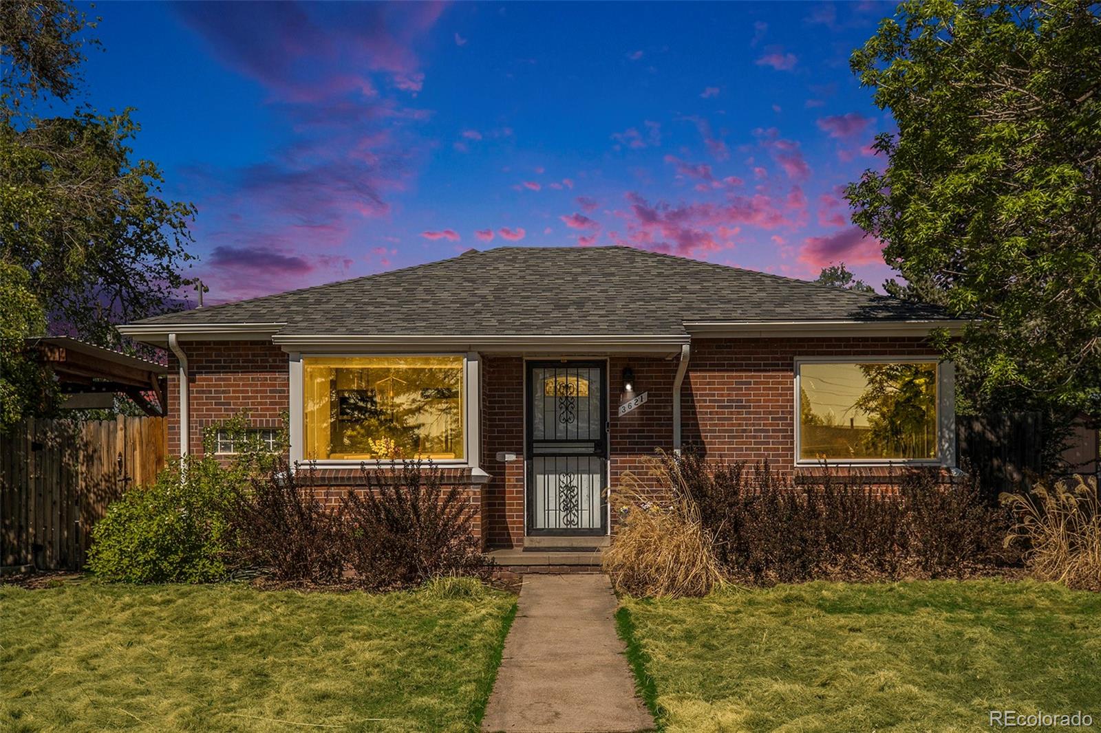 3621 Oneida Street Denver, CO 80207 - Photo 2 of 35 a front view of a house with garden