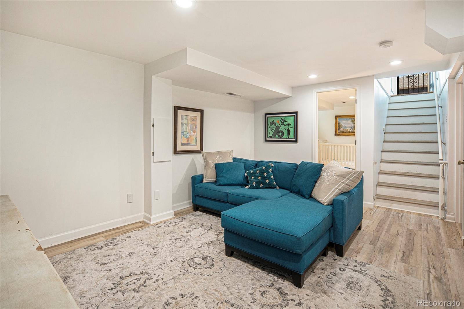 3621 Oneida Street Denver, CO 80207 - Photo 22 of 35 a living room with a couch and a rug