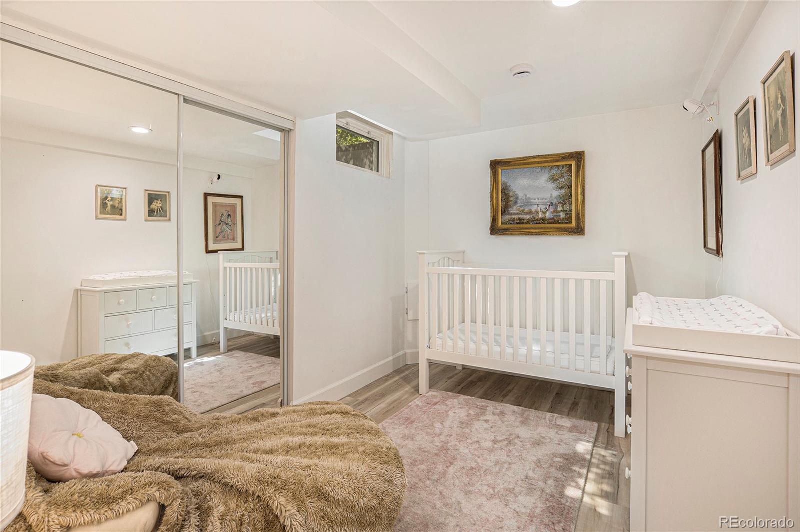 3621 Oneida Street Denver, CO 80207 - Photo 23 of 35 a bedroom with a bed and a window