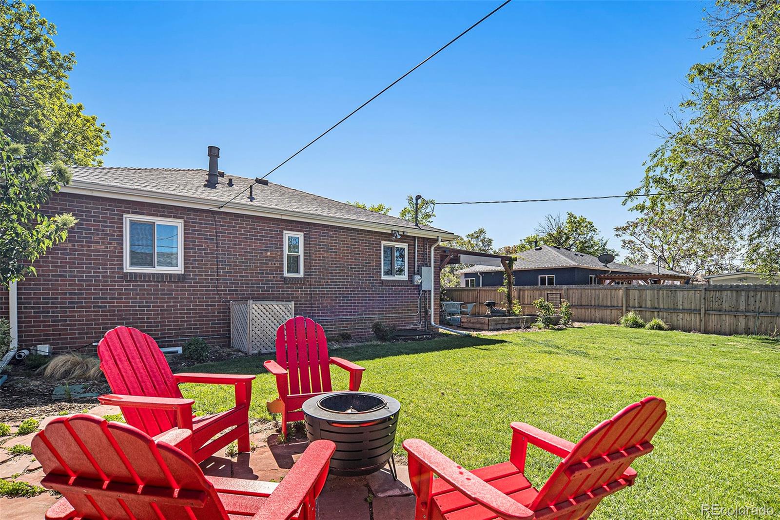 3621 Oneida Street Denver, CO 80207 - Photo 26 of 35 a backyard of a house with yard and outdoor seating