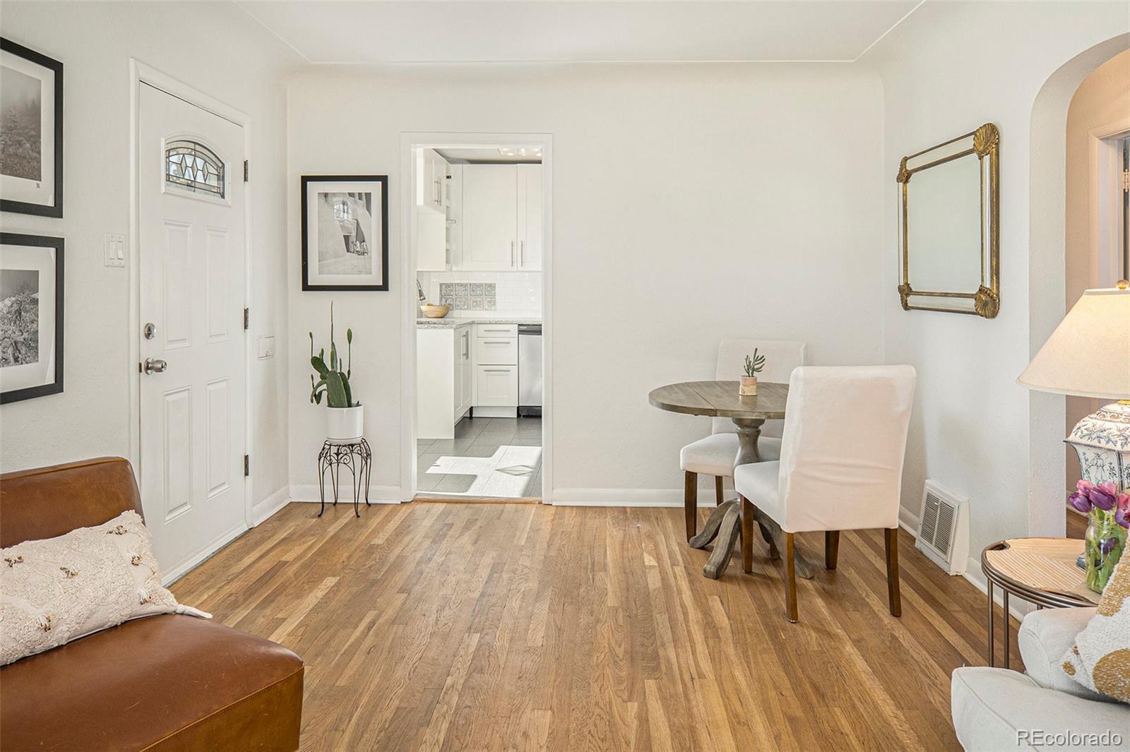 3621 Oneida Street Denver, CO 80207 - Photo 7 of 35 a bedroom with a bed and a chair