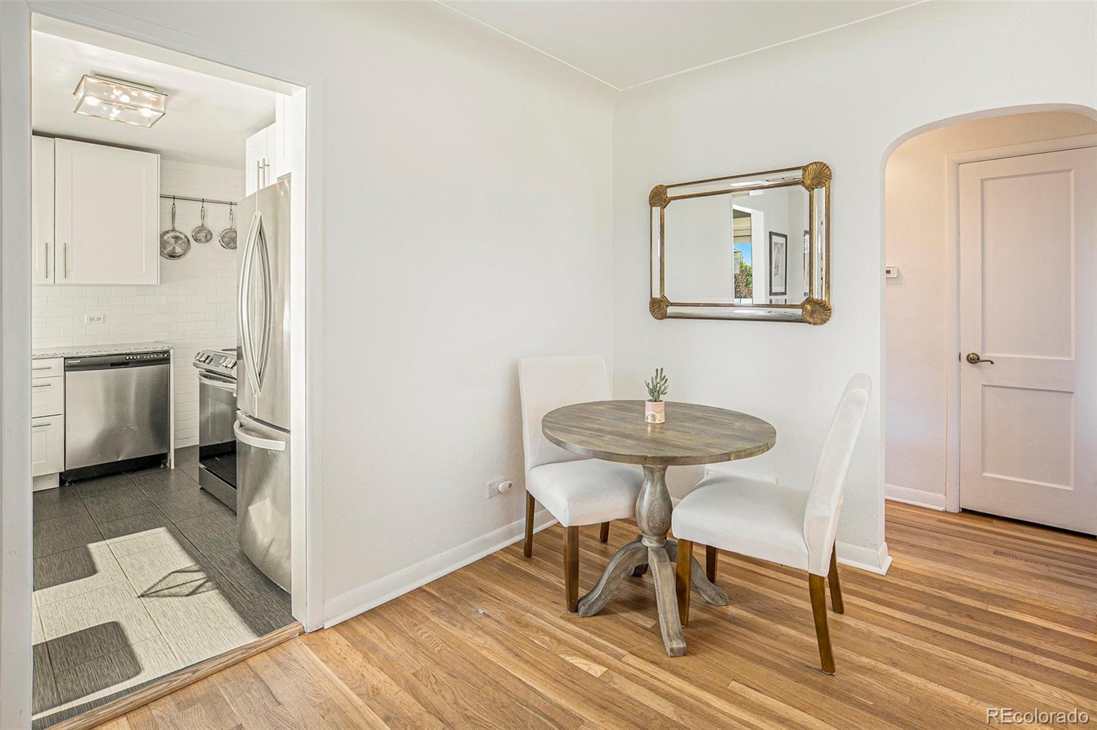 3621 Oneida Street Denver, CO 80207 - Photo 8 of 35 a view of a livingroom with furniture and wooden floor