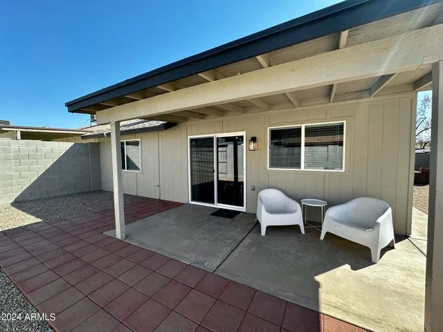 a view of a patio with chair and tables