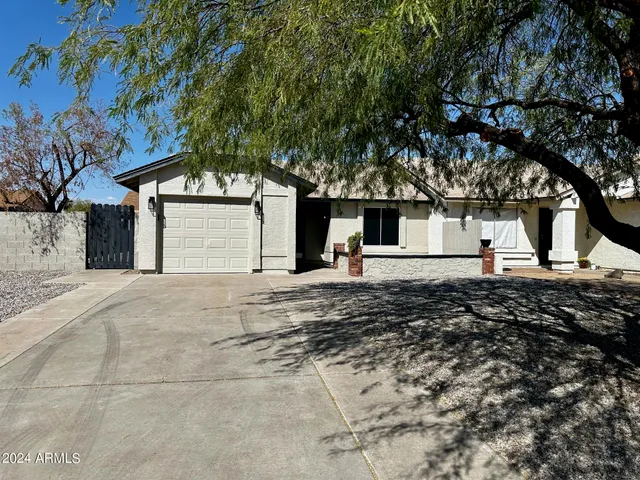 a view of a white house with a yard