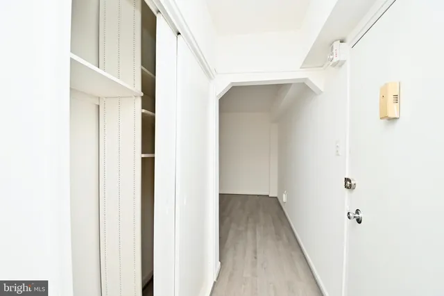 a view of a hallway with wooden floor