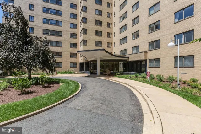 front view of a brick building with a yard