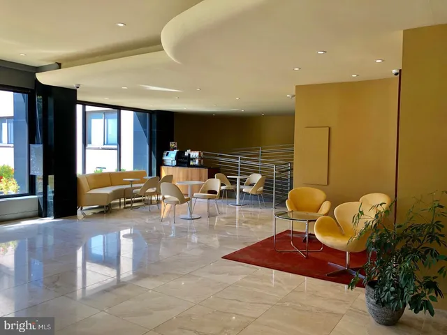 a lobby with furniture and a potted plant