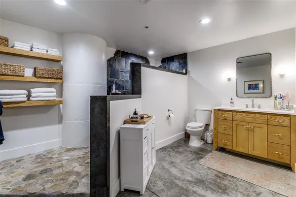 a bathroom with a sink mirror vanity and toilet