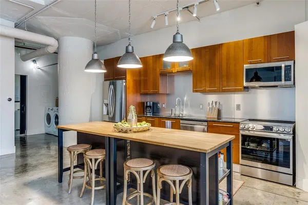 a kitchen with a table chairs stove and microwave