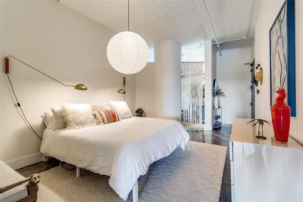 a bedroom with a bed and a chandelier