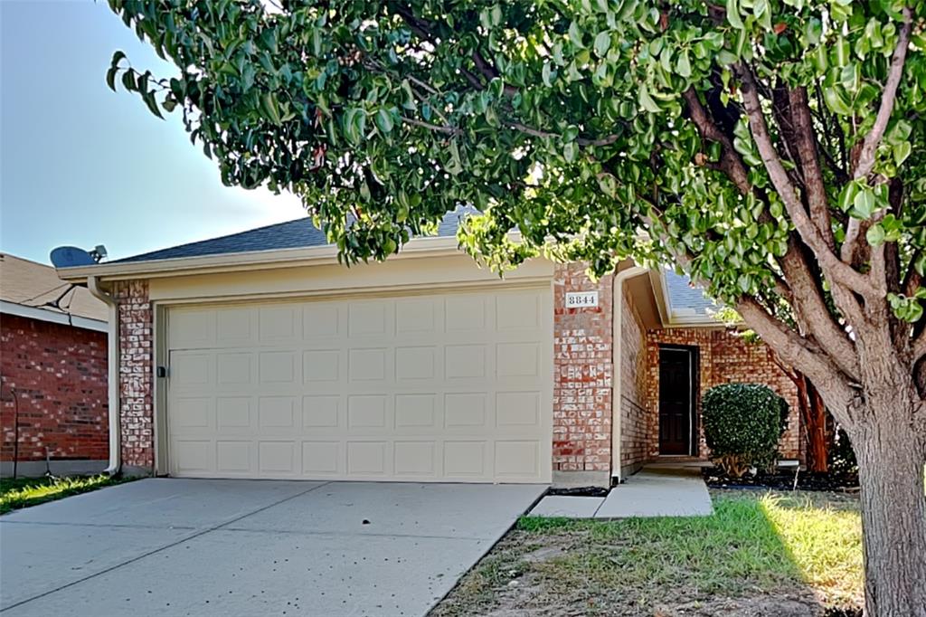 8844 Quarry Ridge Trail Fort Worth, TX 76244 - Photo 1 of 18 View of front of home featuring concrete driveway, a garage, and brick siding