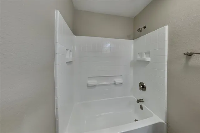 a bathroom with a granite countertop sink a toilet and shower