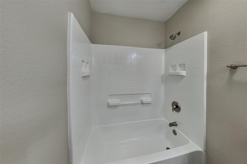 8844 Quarry Ridge Trail Fort Worth, TX 76244 - Photo 14 of 18 Bathroom with a textured wall and bathtub / shower combination