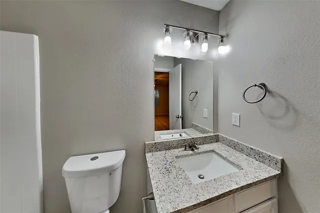 an empty room with a ceiling fan and a window