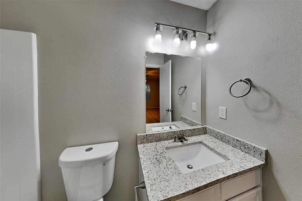 8844 Quarry Ridge Trail Fort Worth, TX 76244 - Photo 7 of 18 Bathroom with a textured wall and vanity