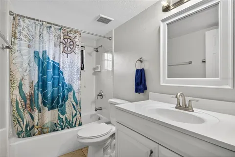 a view of an empty room with a fireplace and a large window