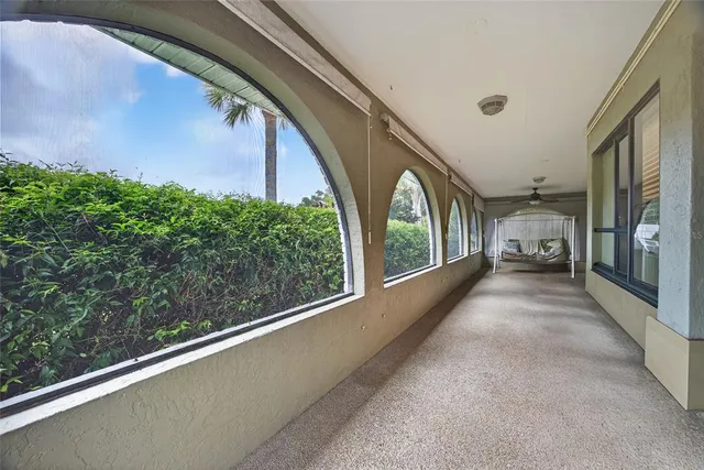 a front view of a house with a yard and potted plants