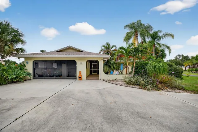 a front view of a house with a garden and a yard